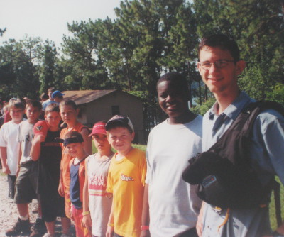 Standing next to my cabin of kids as their camp counselor.